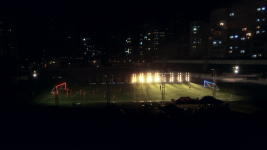 A creatively lit football stadium screenshot from a sports social campaign